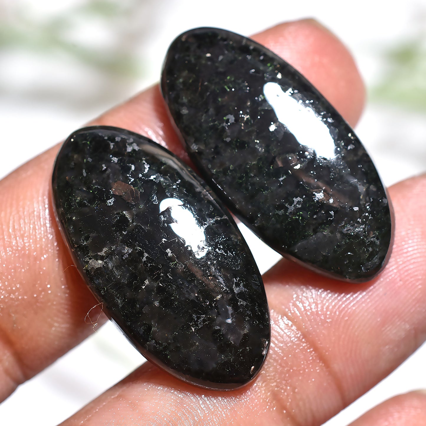 Elegant Nuummite Gemstone Pair – Oval Black Stones with Golden Sparkle
